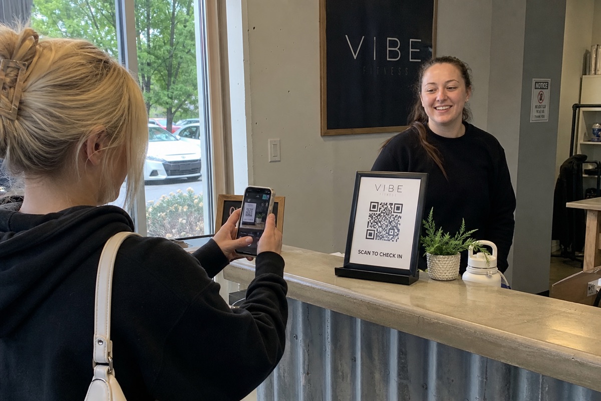 A gym member checking in with a QR code on their phone